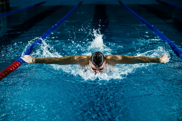 A swimmer mid-stroke in a lap lane