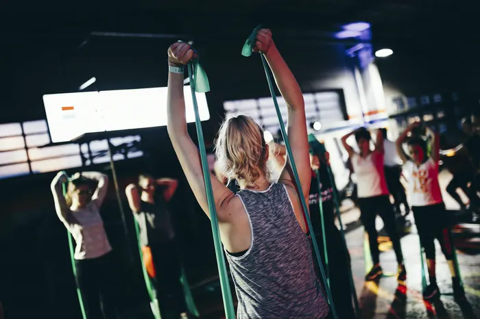 A coached group class training with resistance bands