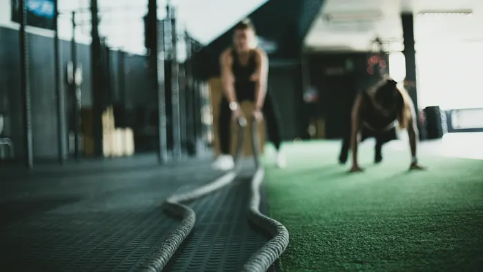 Battle ropes laid out on the turf lane during a conditioning class